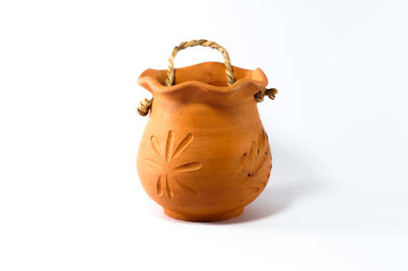 The baked clay jar in the white black groundの写真素材