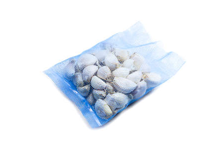 The garlics contain in the blue bag isolated on white backgroundの写真素材