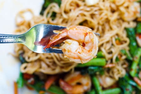 The close up shrimp in spicy noodles basilの写真素材