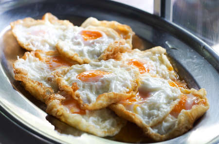 Fried eggs for cooking in the restaurantの写真素材