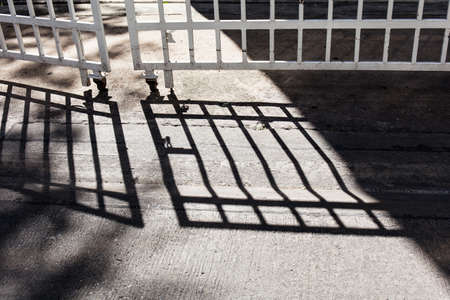shadow from fence on streetの写真素材