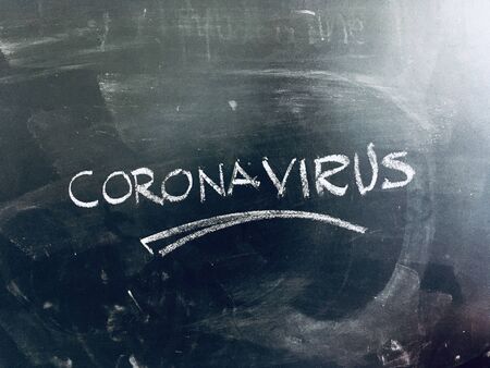 CoronaVirus Covid-19 handwritten on Blackboard as JPG Fileの写真素材