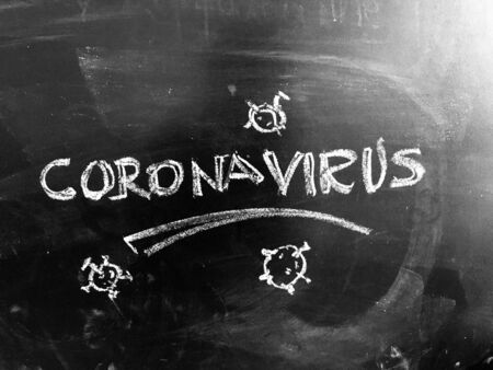 CoronaVirus Covid-19 handwritten on Blackboard as JPG Fileの写真素材