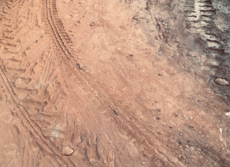 Tyre Marks on Red Mud Grunge Texture Background  as JPG Fileの写真素材