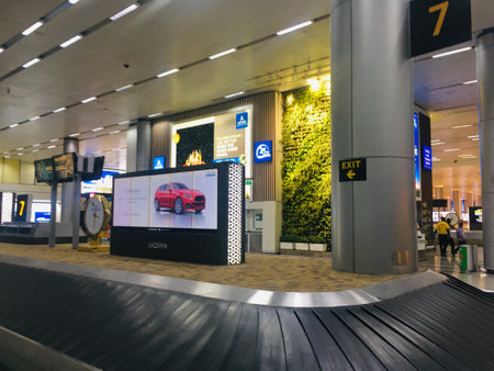 Baggage Carousel at Arrival Hall with Direction Signage at New Terminal Extension at Rajiv Gandhi International Airport - Hyderabad,  India on 11th June 2024のeditorial素材