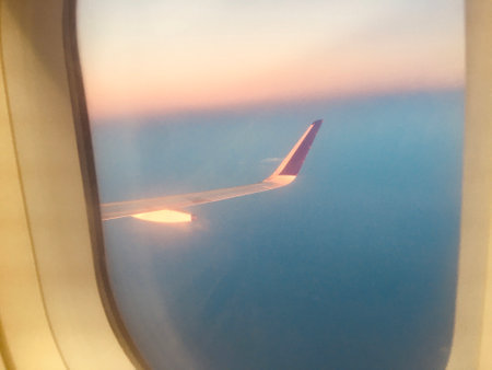 Tourism Aspiration Concept - Sky view of wing from Airplane Window - Stock Image as JPG File