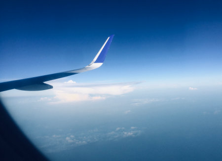 Tourism Aspiration Concept - Sky view of wing from Airplane Window - Stock Image as JPG Fileの写真素材