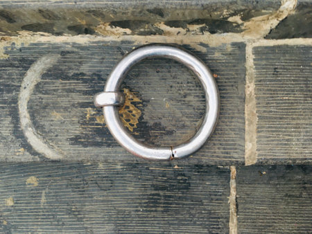 Anchor steel rings on stone surface - Stock Image as JPG File