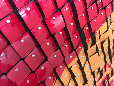 Red and Yellow metal tags creating a Pattern - Stock Image as JPG Fileの写真素材