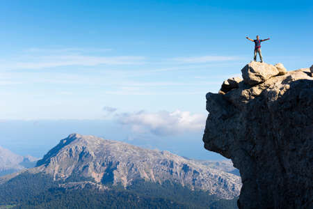 Man on top of the mountain. Location: Serra de Tramuntana, Mallorca. In the background the Tomir mountain.の写真素材