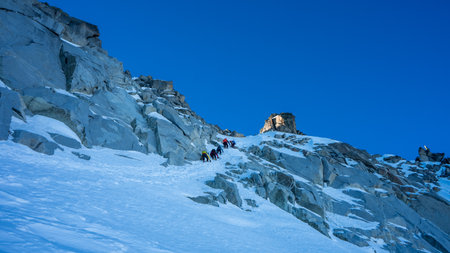Group of friends crossing the most difficult part of the route before the summit