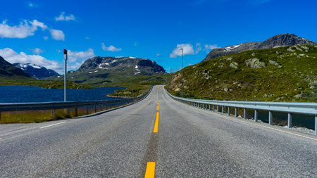 infinite road on a sunny day in Norwayの写真素材