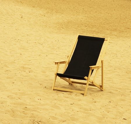black chair in a sandy beachの写真素材