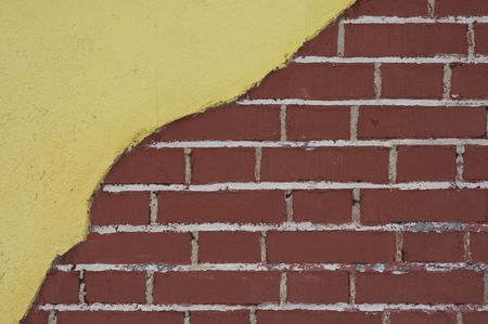 red brick wall with yellow stuccoの写真素材