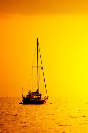 yacht silhouette in sunset lightの写真素材