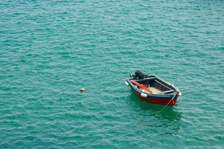 red fishing boat in green waters