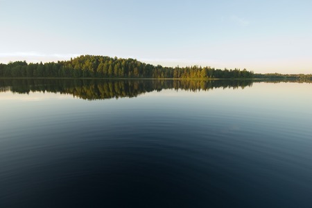 deep blue waters of forest lakeの写真素材