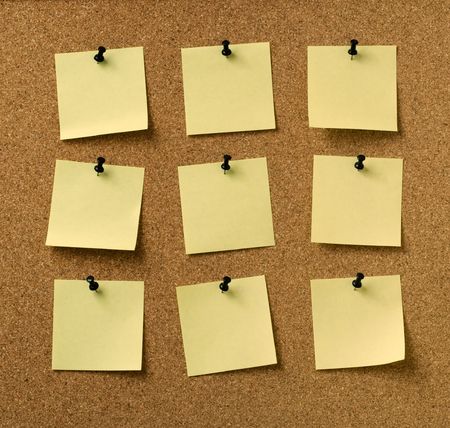 nine yellow notes pinned to cork background