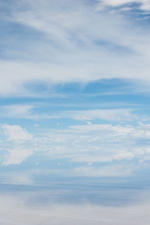cloudy blue sky reflecting in the water