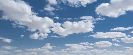 white clouds over deep blue sky background