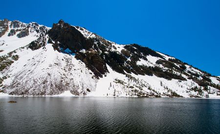 Snowy mountain reflecting in the lake, Yosemite National Park, California, USAの写真素材