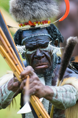WAMENA, PAPUA, INDONESIA - November, 14: Yali Mabel, the chief of Dani tribe performing traditional fighting dance on November, 14, 2008 near Wamena, Papua, Indonesia.のeditorial素材