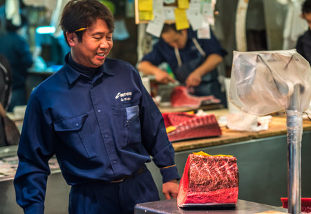TOKYO, JAPAN - November, 22, 2014: Tuna sellers at Tsukiji, the biggest fish and seafood market in the world.のeditorial素材