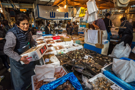 TOKYO, JAPAN - November, 22, 2014: Seafood sellers at Tsukiji, the biggest fish and seafood market in the world.のeditorial素材