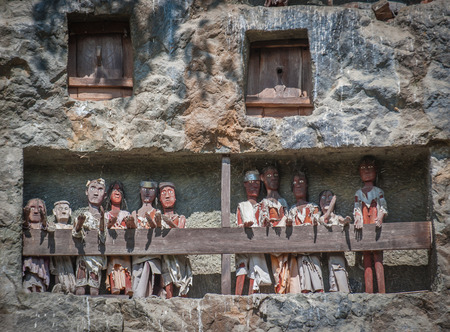 Tau tau, wooden statues representing dead men at burial cave, Tana Toraja, South Sulawesi, Indonesia