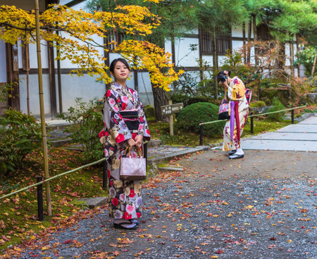 KYOTO, JAPAN - November, 18, 2014: Two japanese girls in traditional kimono, momiji season in Kyotoのeditorial素材