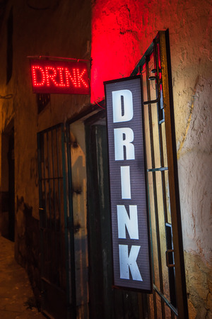 Drink neon sign at the entrance of a barの写真素材