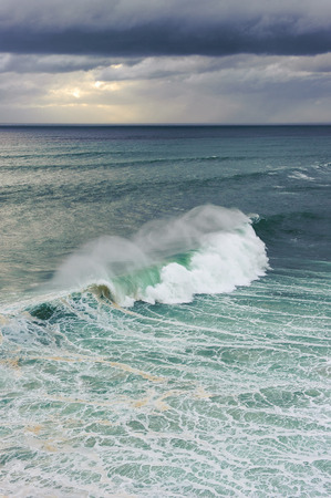 Huge ocean wave breaking in Nazare, Portugalの写真素材