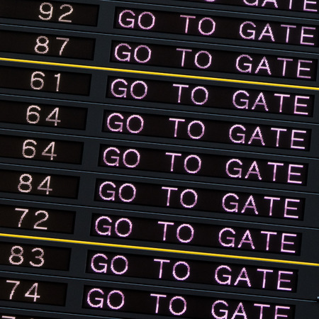 Airport departure board with go to gate sign.の写真素材