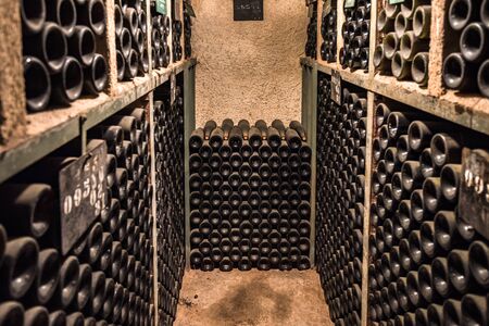 Vintage wine bottles in a cellarの写真素材