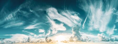 panorama of blue cloudy sky and rising sunの写真素材