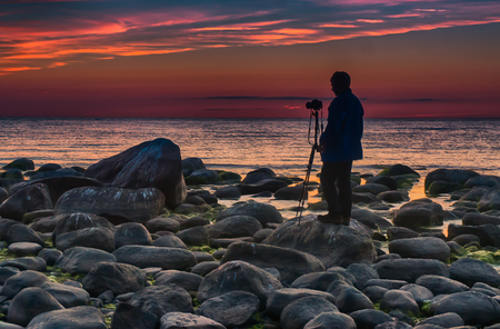Travel in Latvia - Baltic sea sunset on rock beachの写真素材