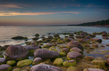 Travel in Latvia - Baltic sea sunset on rock beachの写真素材