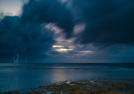 Storm weather with lightning on sea beach
