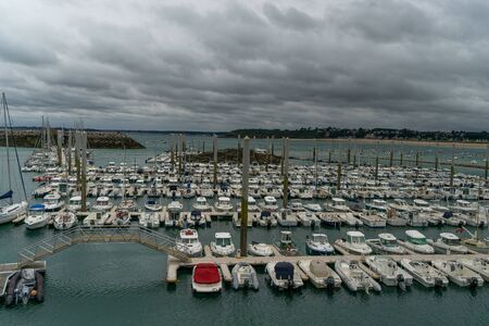 Sea and yachts during tide on sea shore of France in summerの写真素材