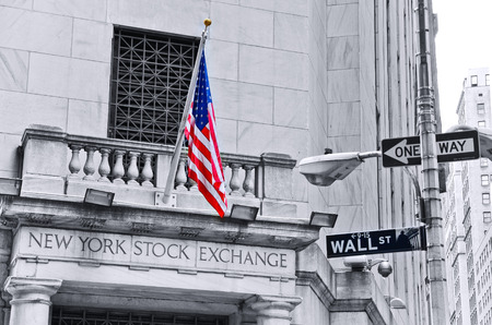 . NEW YORK CITY, NY - OCT 11: The side entrance of New York Stock Exchange and a street sign of Wall...