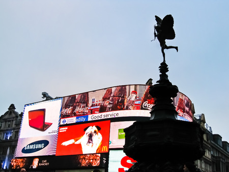 LONDON - October 8: Illuminated billboard with Statue of Cupid in Piccadilly Circus on October 8, 2010 in London Famous advertisements of Samsung, McDonalds, and Coca-Cola were displayed on the electronic billboard..のeditorial素材