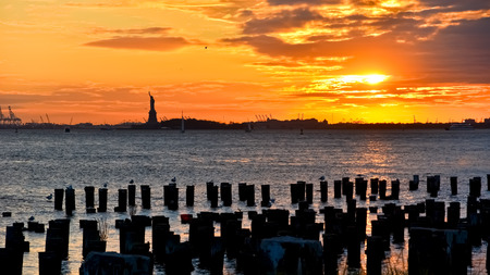 View of Statue of Liberty at sunset in New York.の写真素材