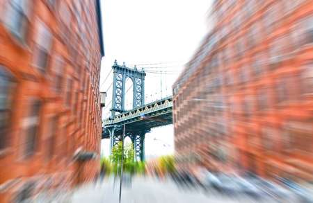 Manhattan Bridge seen between buildings in New York City with motion effectの写真素材