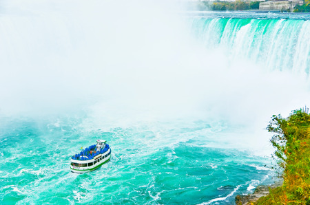 View of the tour boat - Maid of the Mist with lots of tourists visiting Niagara Falls on October 13, 2013.のeditorial素材