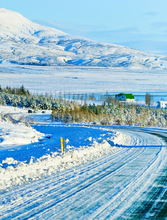 Car driving on the icy road in winter on the plateau in Iceland.の写真素材