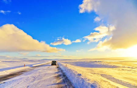 A car driving on the icy road from the plateau around the Thingvellir National Park in Iceland in winter.の写真素材
