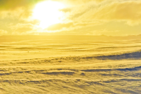 View of the sunrise on the snowy plateau in winter in Iceland.の写真素材
