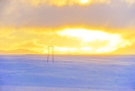 View of the sunrise on the snowy plateau in winter in Iceland.の写真素材