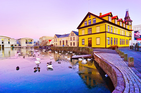 View of the houses along the Tjornin Lake in Reykjavik at dawn in winter on January 28, 2017.のeditorial素材