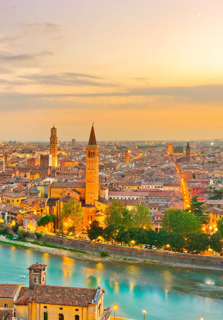 View of the historic city center along Adige river at sunset in Verona, Italy.